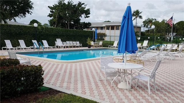 view of swimming pool featuring a patio area