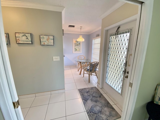 entrance foyer with crown molding and light tile patterned flooring