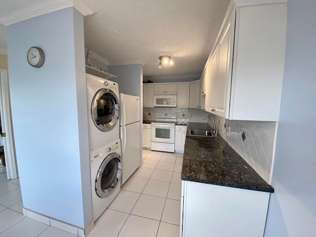 washroom with stacked washer / drying machine, light tile patterned flooring, sink, and crown molding