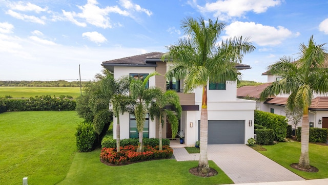 view of front of house with a garage and a front yard