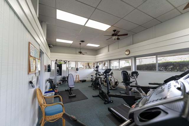 gym featuring ceiling fan and a drop ceiling