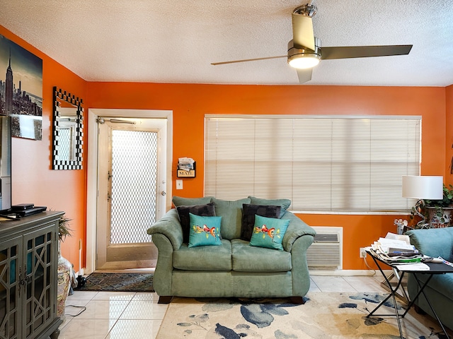 tiled living room featuring ceiling fan and a textured ceiling