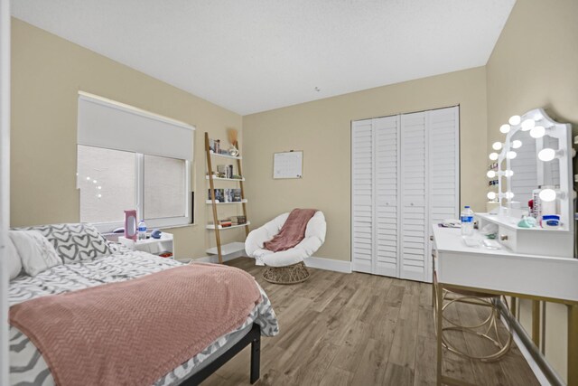 bedroom featuring light hardwood / wood-style floors and a closet