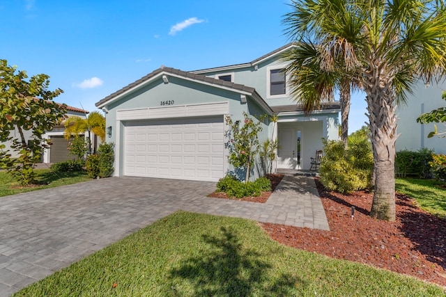 view of front of home with a front yard and a garage