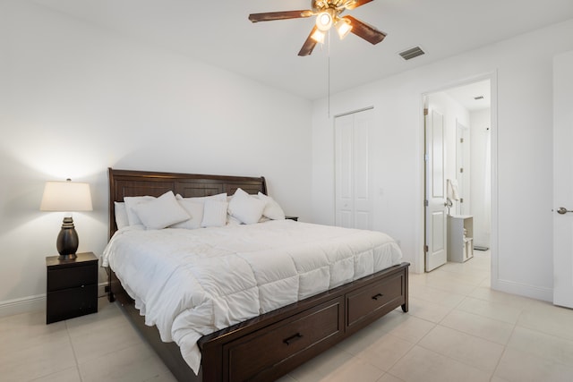 bedroom with a closet, ceiling fan, and light tile floors