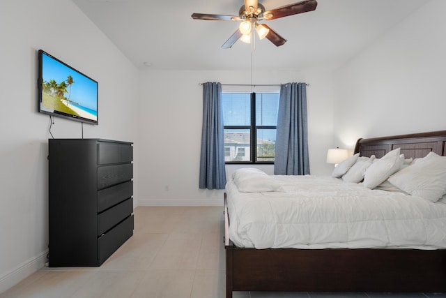 bedroom featuring ceiling fan and light tile floors