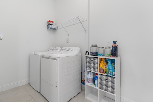 washroom featuring washer and clothes dryer and light tile flooring