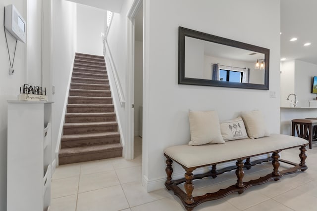 stairway with light tile floors