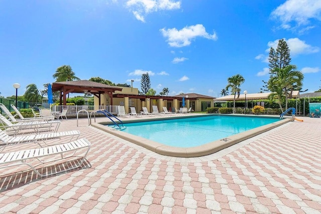 view of swimming pool featuring a gazebo and a patio area