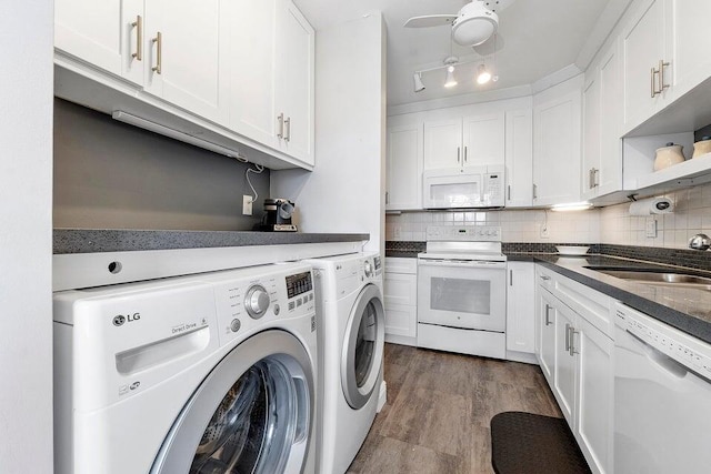 washroom featuring hardwood / wood-style floors, ceiling fan, separate washer and dryer, and sink