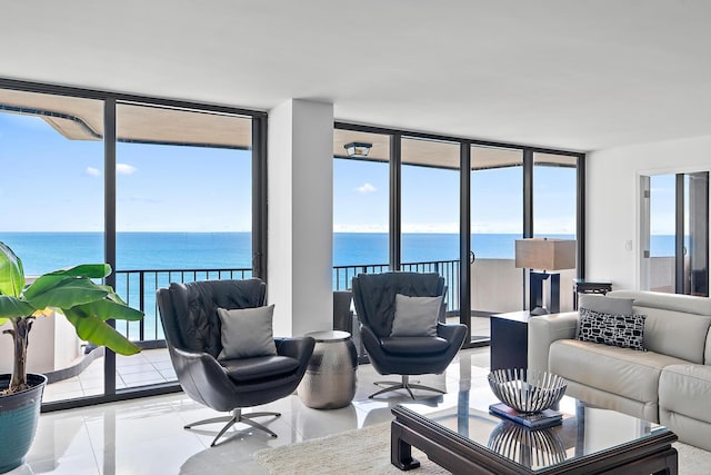 living room with a water view, a wealth of natural light, and a wall of windows