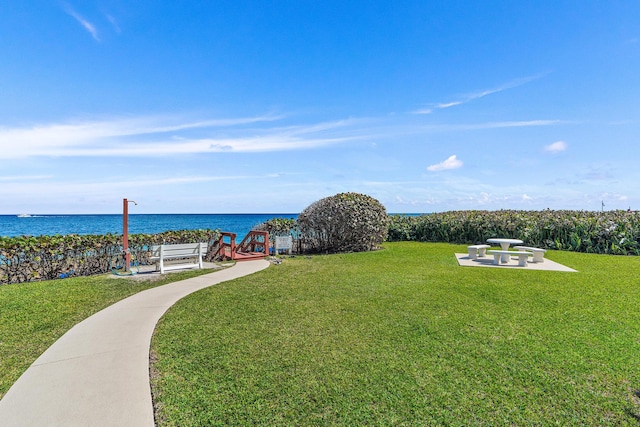 exterior space with a lawn and a water view