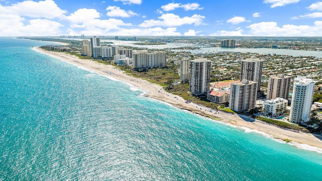 drone / aerial view featuring a water view and a view of the beach