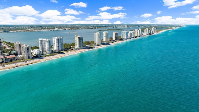 drone / aerial view featuring a water view and a view of the beach