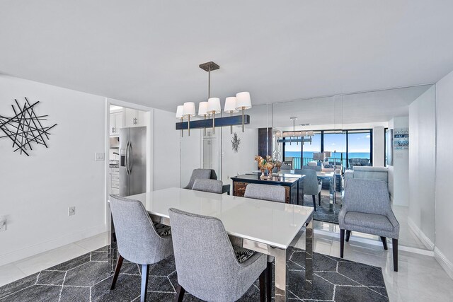 dining space featuring a wall of windows and a notable chandelier