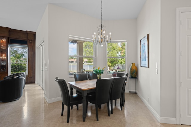 dining space with a chandelier and light tile floors