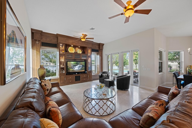 living room featuring a wealth of natural light, ceiling fan, and french doors