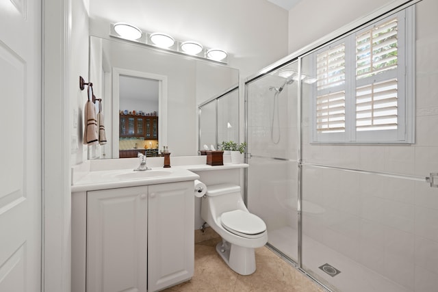 bathroom with vanity, a shower with shower door, toilet, and tile flooring