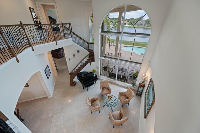 living room with tile flooring and a high ceiling