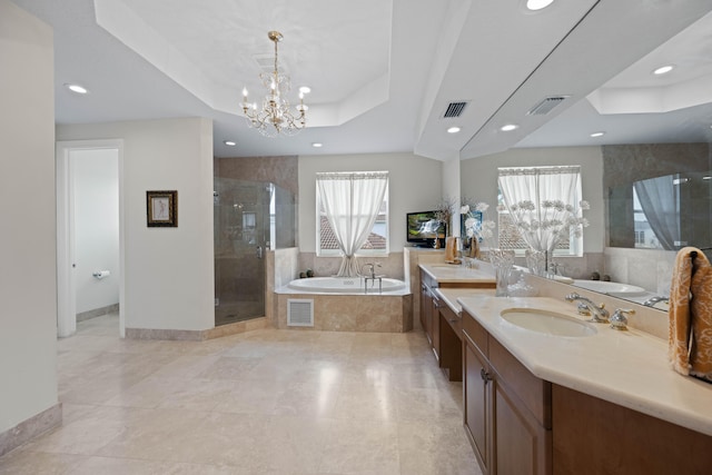 bathroom with a wealth of natural light, tile floors, separate shower and tub, and a tray ceiling