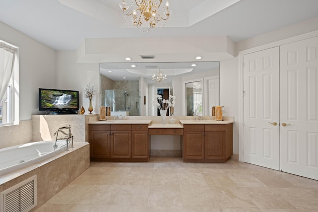 bathroom featuring tile flooring, vanity, a chandelier, and a tray ceiling