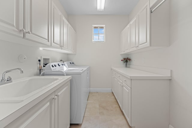 clothes washing area with cabinets, light tile floors, sink, washer hookup, and separate washer and dryer