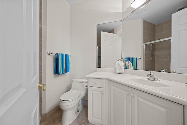 bathroom with toilet, tile floors, and vanity