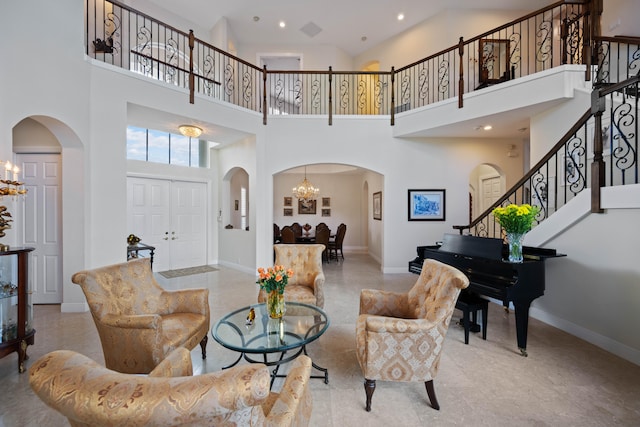 living room featuring a high ceiling and a chandelier