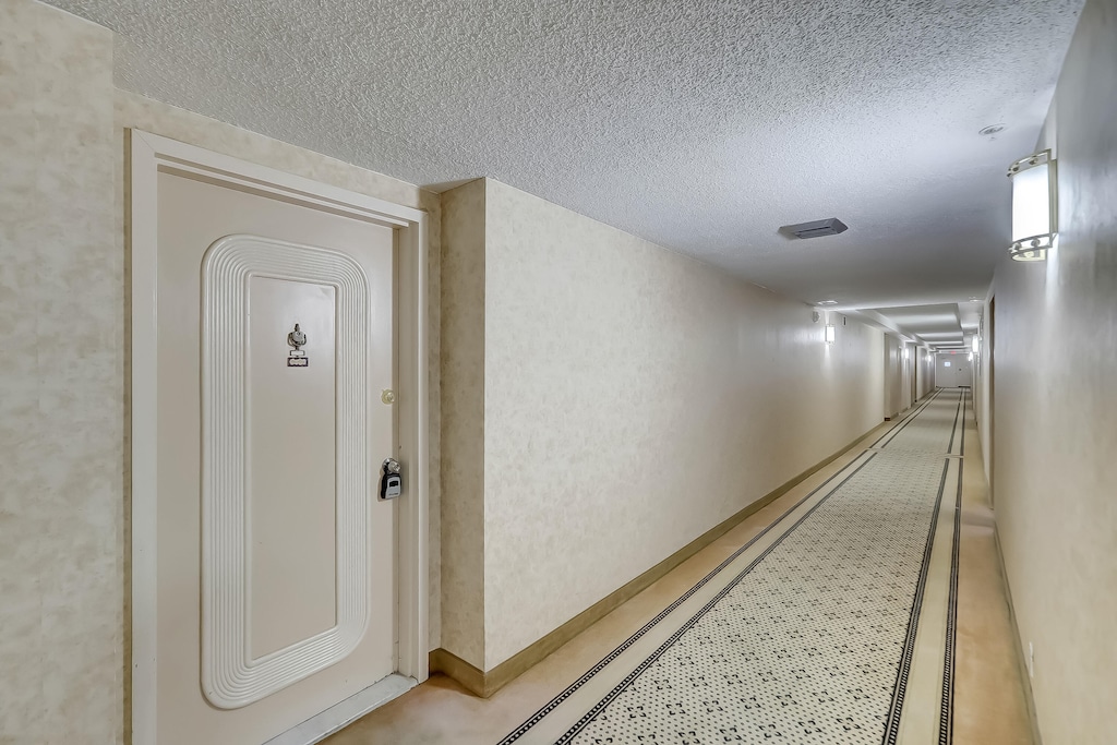 hallway with a textured ceiling