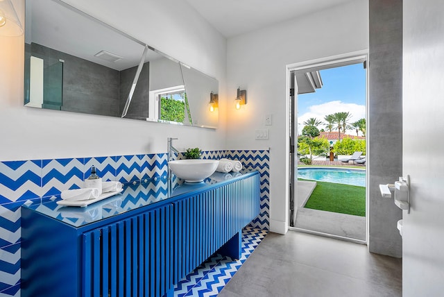 bathroom with concrete flooring and vanity