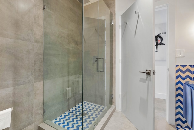 bathroom featuring tile flooring and an enclosed shower