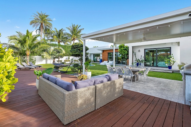 wooden terrace featuring outdoor lounge area and ceiling fan