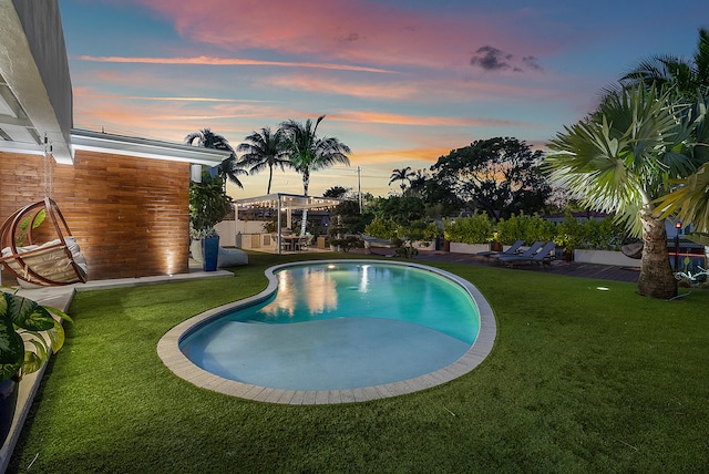 pool at dusk with a lawn