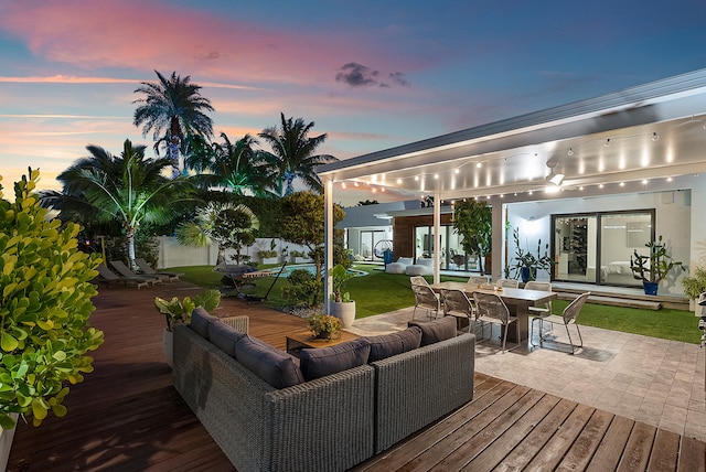 deck at dusk featuring an outdoor living space