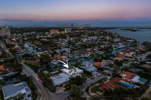 aerial view at dusk with a water view