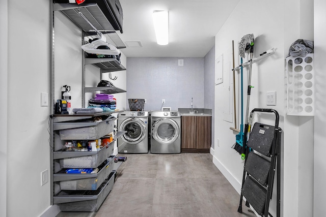 clothes washing area featuring independent washer and dryer and sink