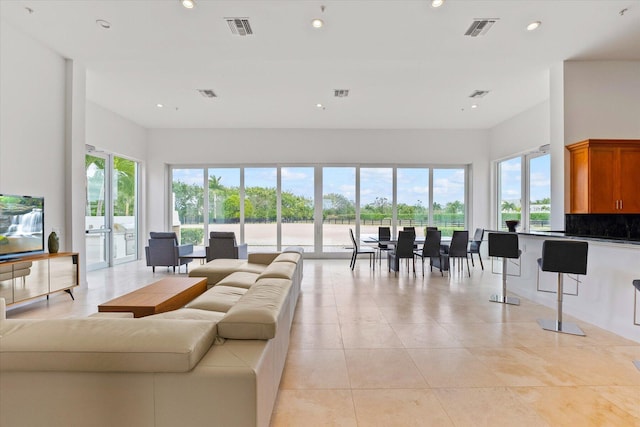 living room featuring light tile floors and french doors