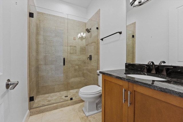 bathroom featuring vanity, tile floors, a shower with shower door, and toilet