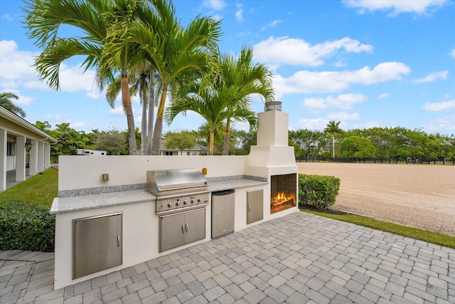 view of terrace featuring area for grilling and exterior kitchen