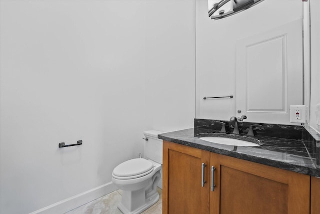 bathroom featuring vanity, tile flooring, and toilet