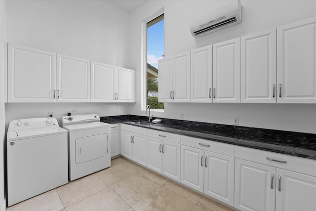 laundry room featuring washing machine and clothes dryer, cabinets, sink, and light tile floors