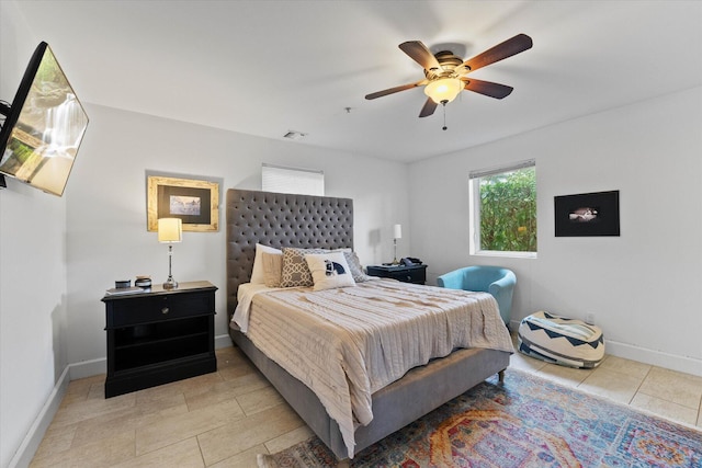 bedroom with ceiling fan and light tile floors