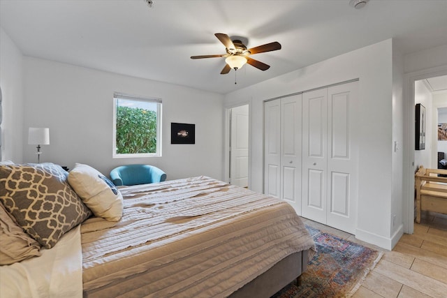 bedroom featuring a closet, ceiling fan, and light tile floors