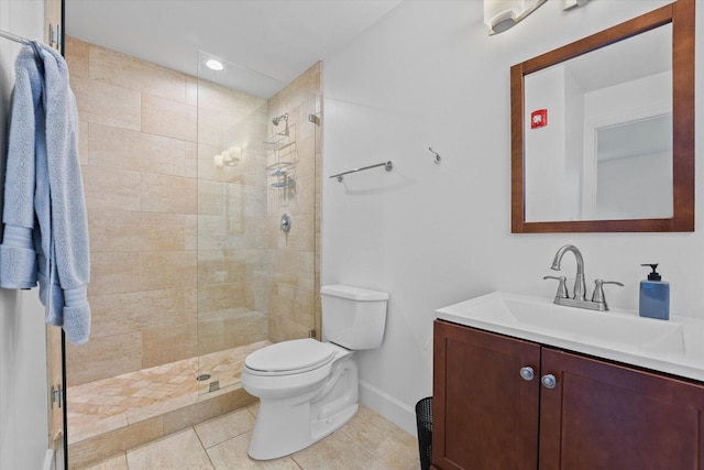 bathroom featuring vanity, tile flooring, toilet, and tiled shower