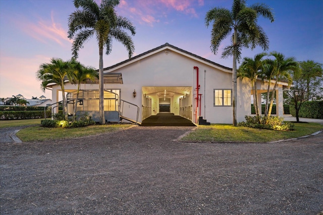 view of front of property with a yard and a carport