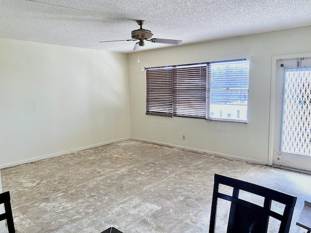 unfurnished room with a textured ceiling and ceiling fan