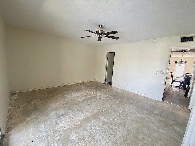 spare room featuring ceiling fan, a textured ceiling, and concrete flooring