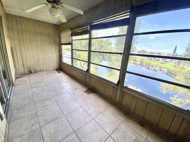 unfurnished sunroom with ceiling fan