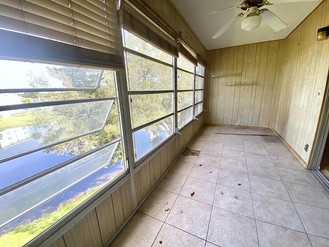 unfurnished sunroom featuring ceiling fan