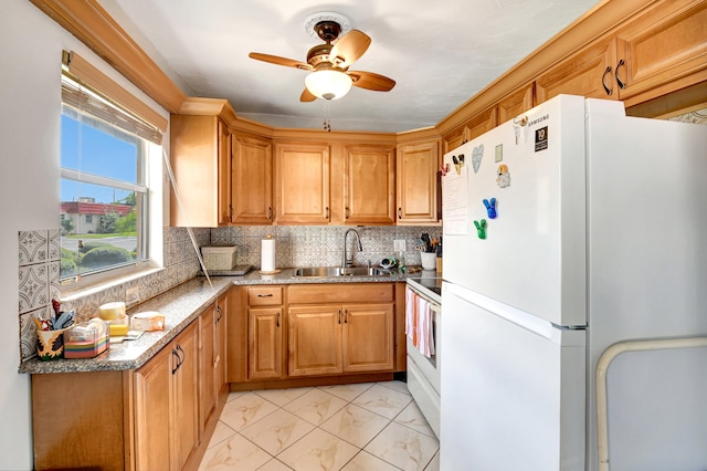 kitchen with white appliances, ceiling fan, sink, light tile floors, and backsplash